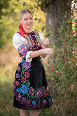 Young beautiful slovak woman in traditional costume. Slovak folklore.