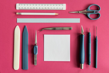 Papercraft tools on pink background
