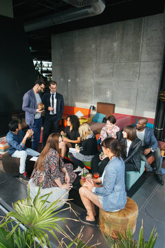 Group of Mixed Race Friends Having Drinks on Sunny Rooftop Bar