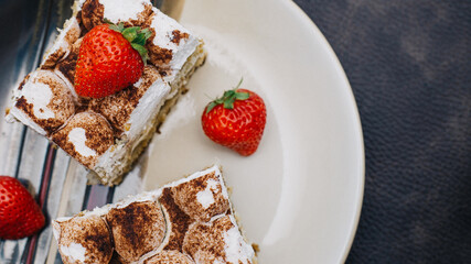 Homemade Tiramisu cake is a traditional Italian dessert with strawberries. Sweet dessert for Breakfast. Calories and excess weight