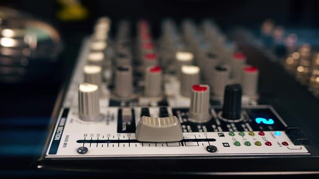 Close-up of main control fader of music studio mixer.