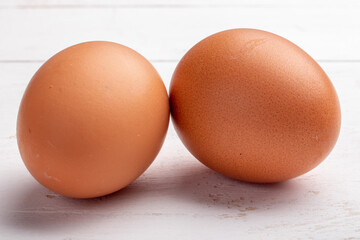 two brown eggs on a white background