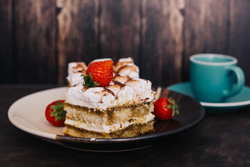 Homemade Tiramisu cake a traditional Italian dessert with strawberries on a dark background