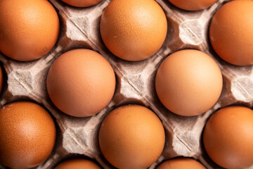 brown chicken eggs in a carton top view