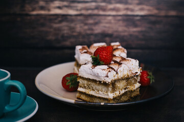 Traditional Italian dessert tiramisu with strawberry, selective focus image