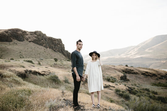 modern fashionable couple posing in desert landscape