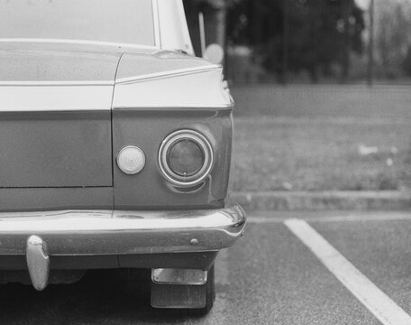 Black and white image of the back of classic american car