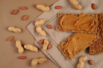 Fototapeta na wymiar Peanut butter and peanut crispbreads on a linen napkin
