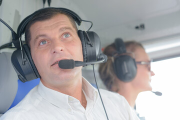 helicopter pilot in the cabin during the flight © auremar