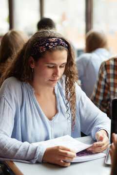 Young woman reading and studying in the university