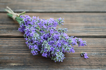 Obraz na płótnie Canvas Fresh fragrant lavender flowers on a rustic wooden table. Close-up, selective focus