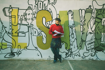Man painting in a graffiti wall