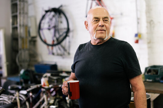 Portrait of Senior adult in Bicycle workshop