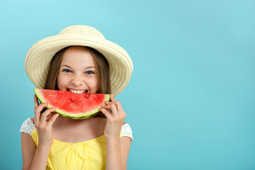 Smiling little girl with blue eyes with a slice of watermelon outdoor