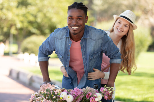 Mixed Couple Ob A Bicycle Outdoors