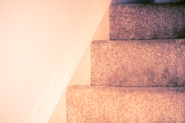 Staircase covered in dark grey carpet