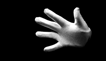 Number five 5 - a male hand wearing white glove isolated on black background. Open hand gestures