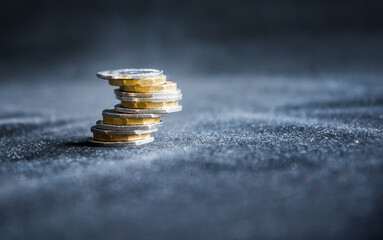 Perth, Scotland - 5 December 2019: One pound coins stacked on a dark background - UK economy