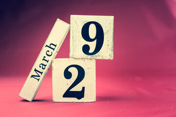 March 29th, Twenty-ninth of March, Day 29 of month March - vintage wooden calendar blocks on maroon background with empty space for text