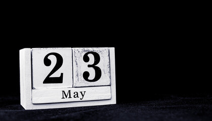 May 23rd, Twenty-third of May, Day 23 of month May - vintage wooden white calendar blocks on black background with empty space for text