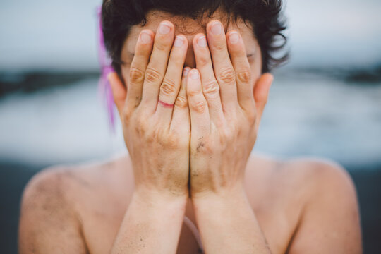 Young woman hiding her face
