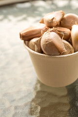 dried garlic clove lies in a paper glass is on the table