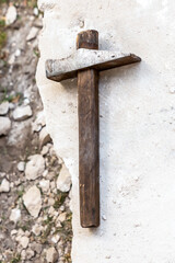 sharp gray hammer lies on a white stone background, the extraction of material on the quarry