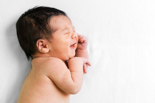 Baby laughing in bed