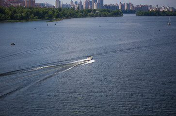 Obraz premium The motor boat sails along the river