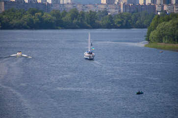 The motor boat sails along the river