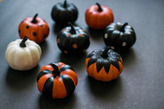 Assorted decorated pumpkins on black.