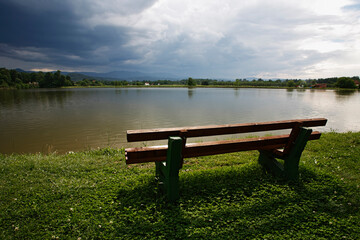 Fototapeta premium Dramatic clouds over the lake. Sunset.