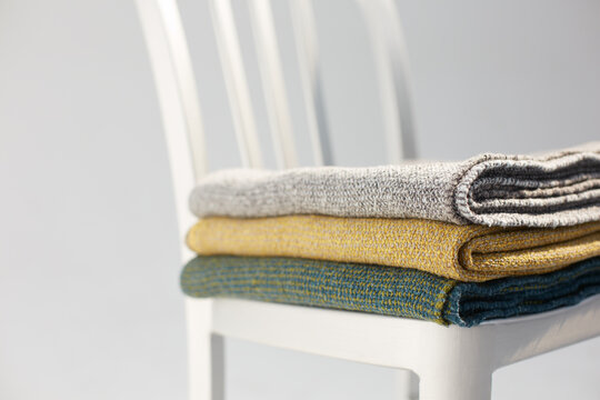 Metallic chair and stack of cotton blankets in the studio