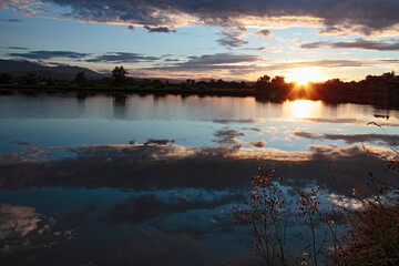 Dramatic clouds over the lake. Sunset.