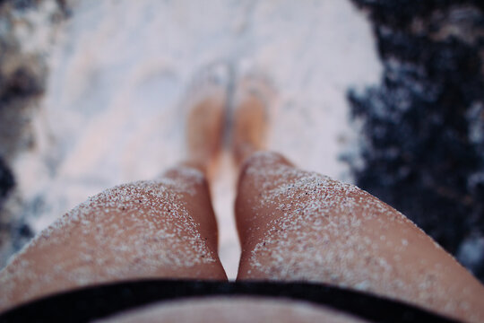 A woman's legs with sand