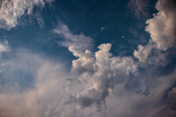natural background with white tufts of cloud, blown by the winds under a heavenly sky.