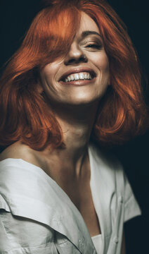 Portrait of hip young ginger female smiling.