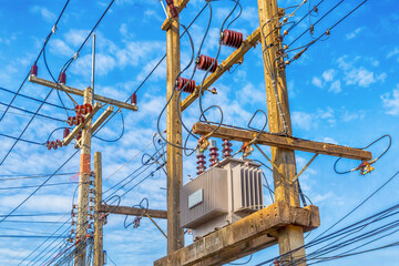 electricity supply system for users, high-voltage power transformers mounted on wooden poles on a...