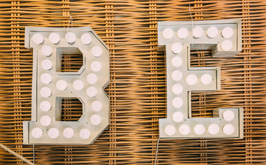 BE Word in a Bulb Metallic Sign