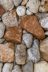 stone background of multi-colored stones uneven gray and brown pattern