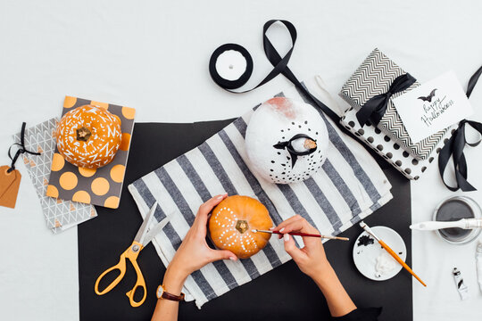Woman Painting Halloween Pumkins