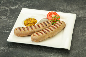 Grilled natural pork sausages with sauce