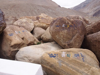 Colourful characters painted on the rocks, Ladakh, Jammu and Kashmir, India