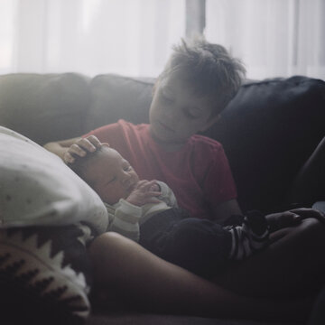 Big brother bonding with his new baby bother