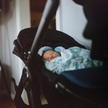 Baby sleeping in his stroller