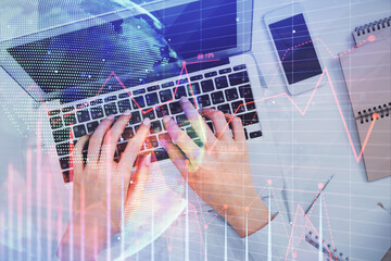 Double exposure of woman hands working on computer and forex chart hologram drawing. Top View. Financial analysis concept.
