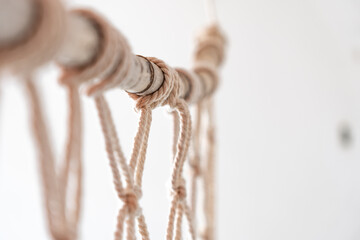 Sea-worn bamboo cane used for macrame curtain, light colors and white
