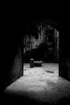 Old well within the fortress seen trough a passage