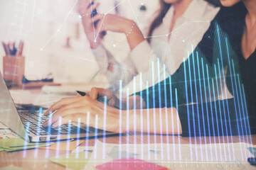 Fototapeta premium Multi exposure of woman hands typing on computer and financial graph hologram drawing. Stock market analysis concept.