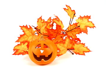 Halloween pumpkin and maple leaves isolated on white background
